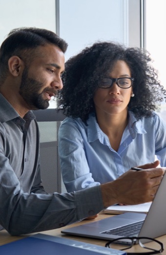 Man and woman looking at laptop