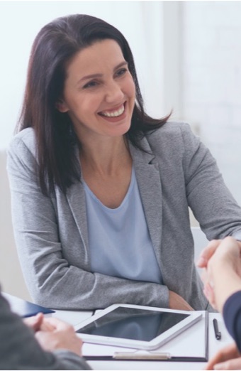 Agent smiling and shaking customer's hand